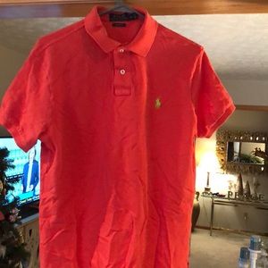 Red/orange short sleeved polo with yellow symbol